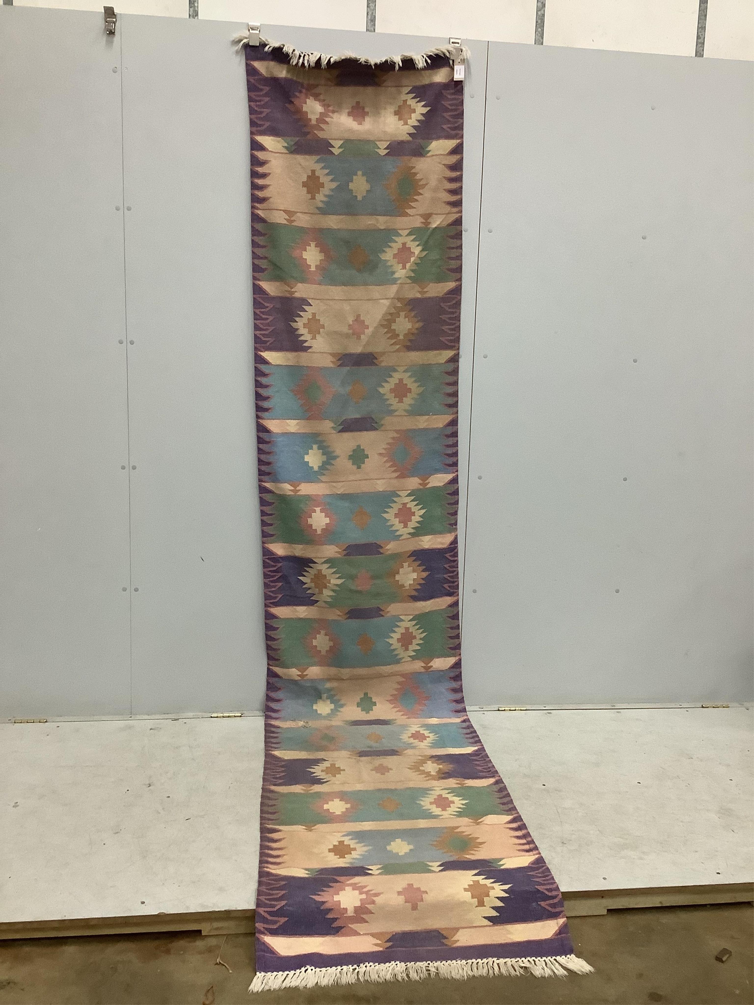 A Kilim flat weave runner, 360cm x 74cm. Condition - poor to fair, holed.